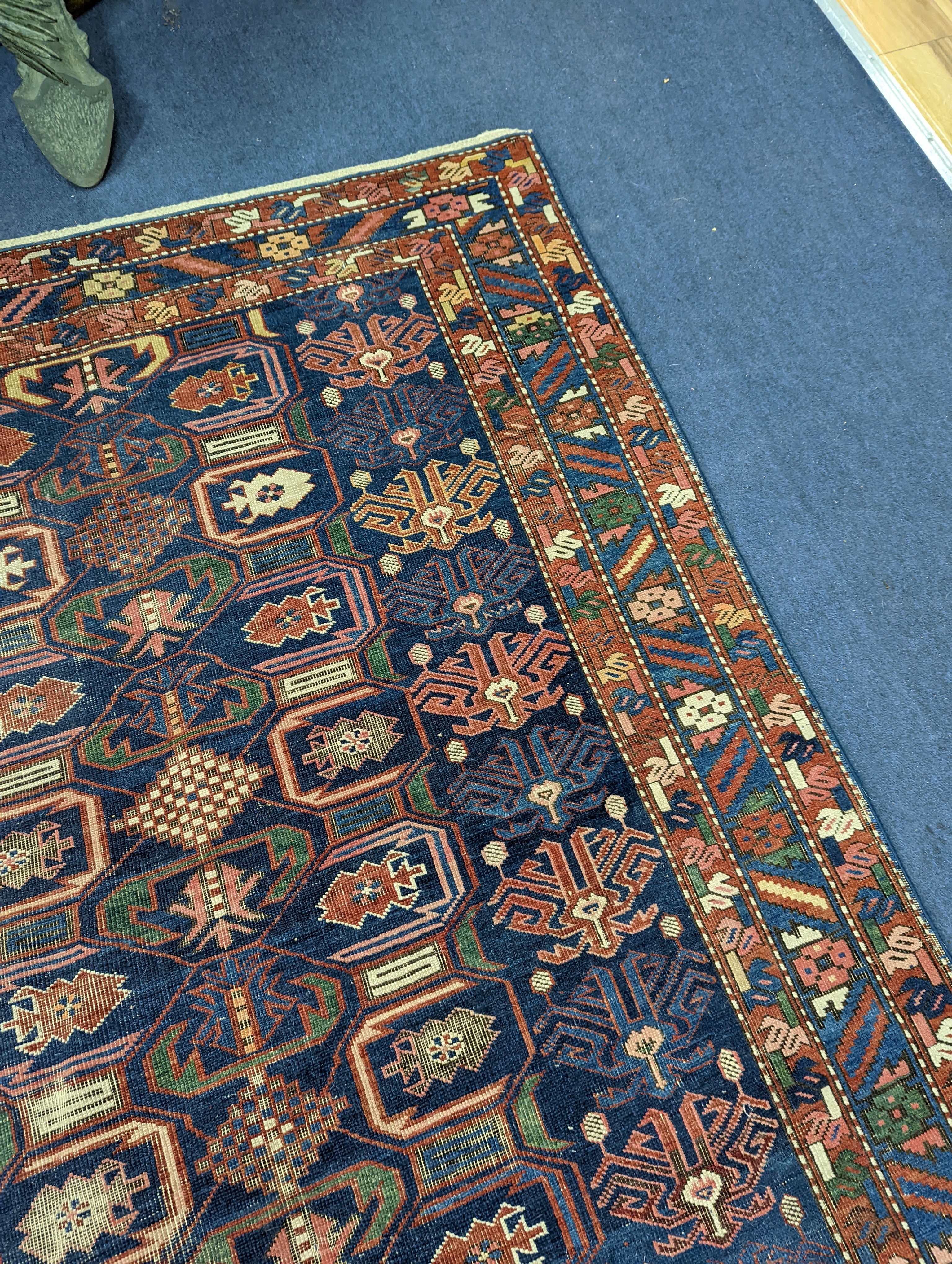 An antique Caucasian blue ground rug, 260 x 130cm